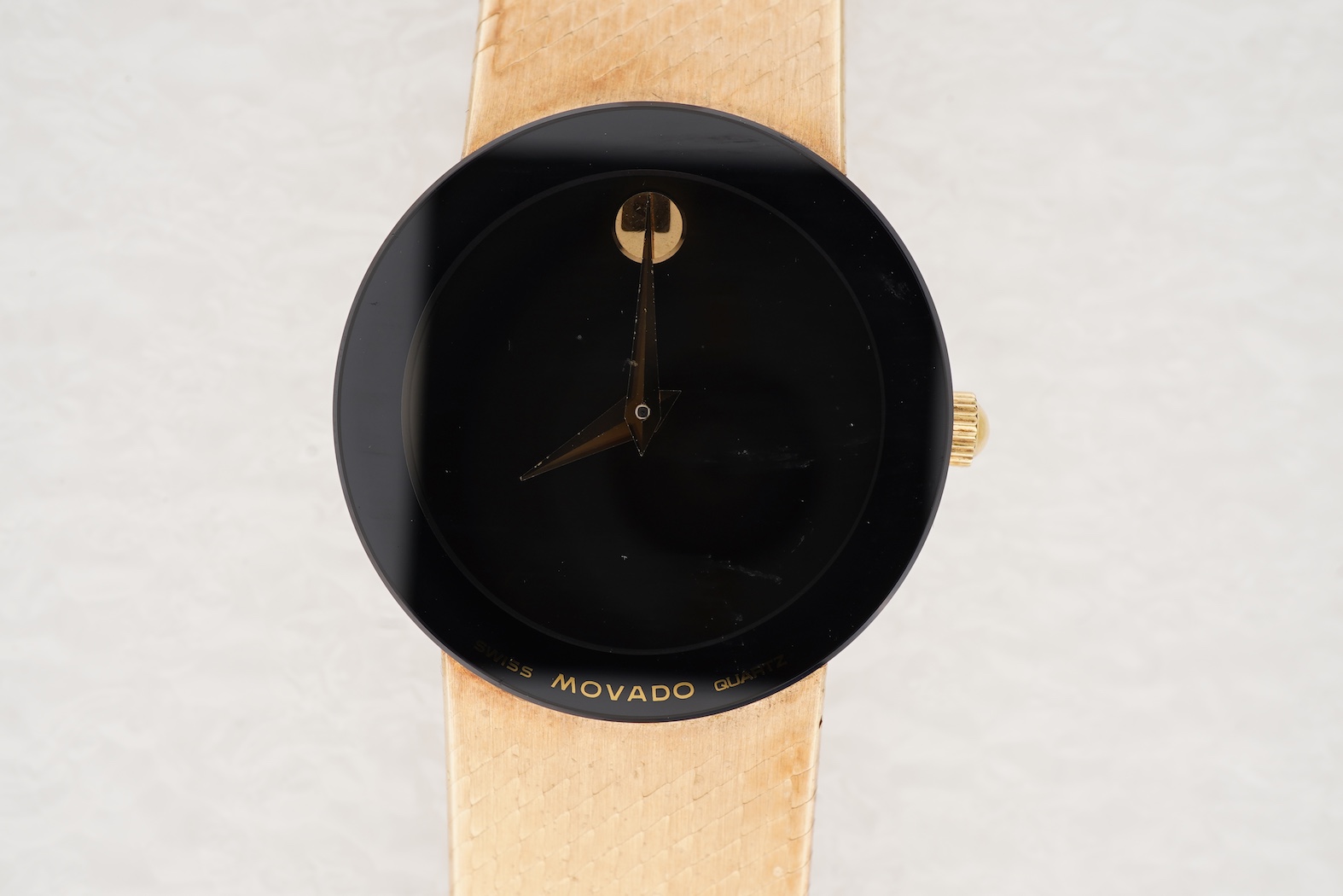 A lady's late 20th century Swiss Movado Museum 14k yellow metal quartz wrist watch, on an integral Italian 14k bracelet